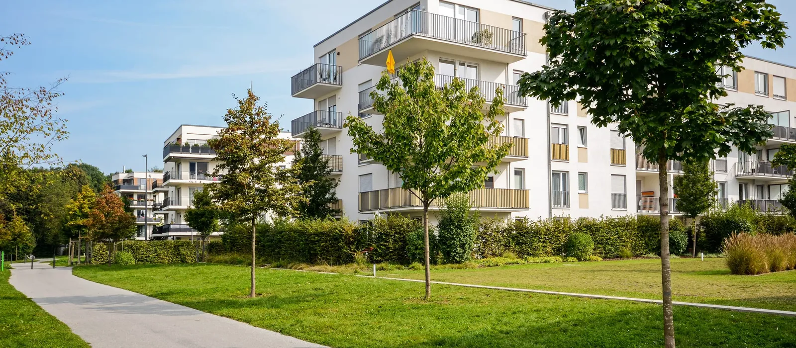 New multi-storey apartment building with balconies and landscaped grounds