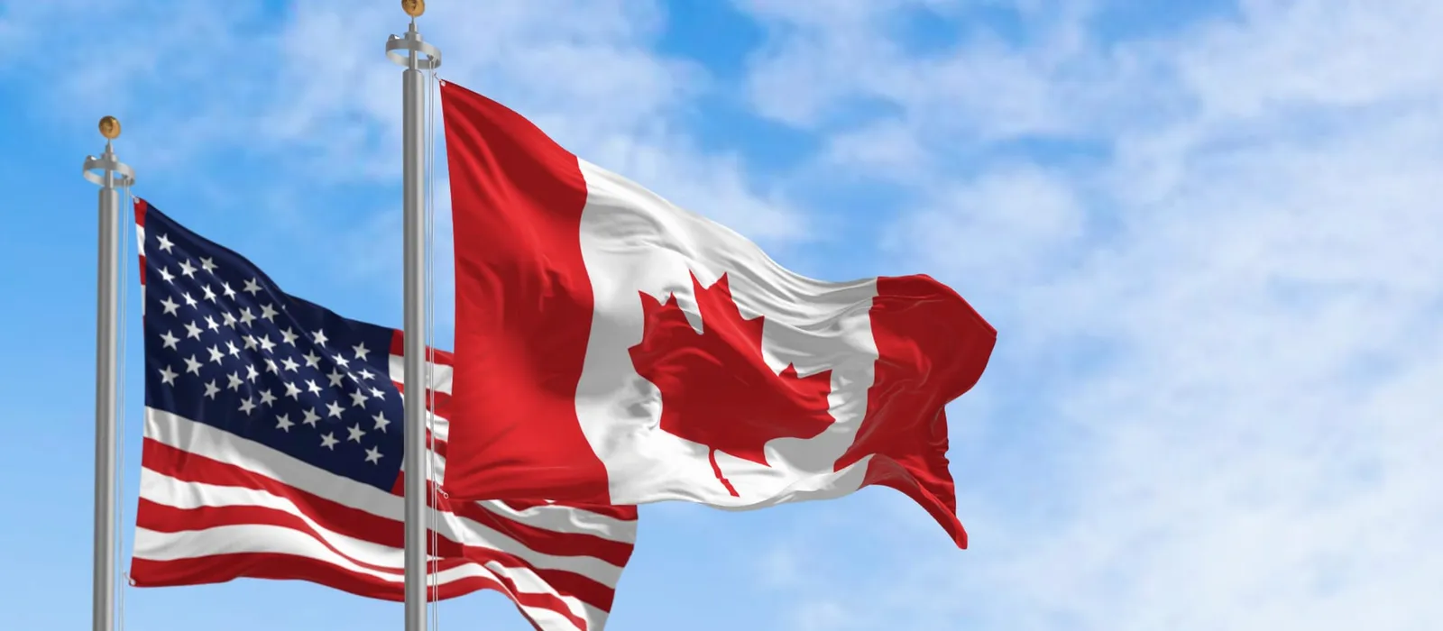 Canadian and American flags flying side by side