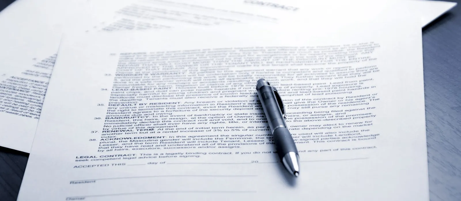 Pen resting on a contract ready for signature