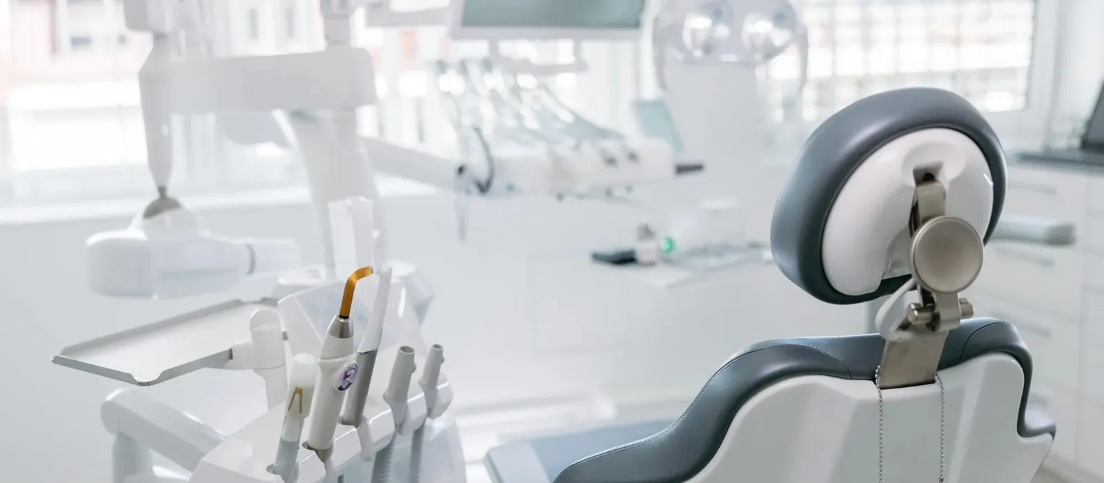 Empty dentist chair and drills in a dental office
