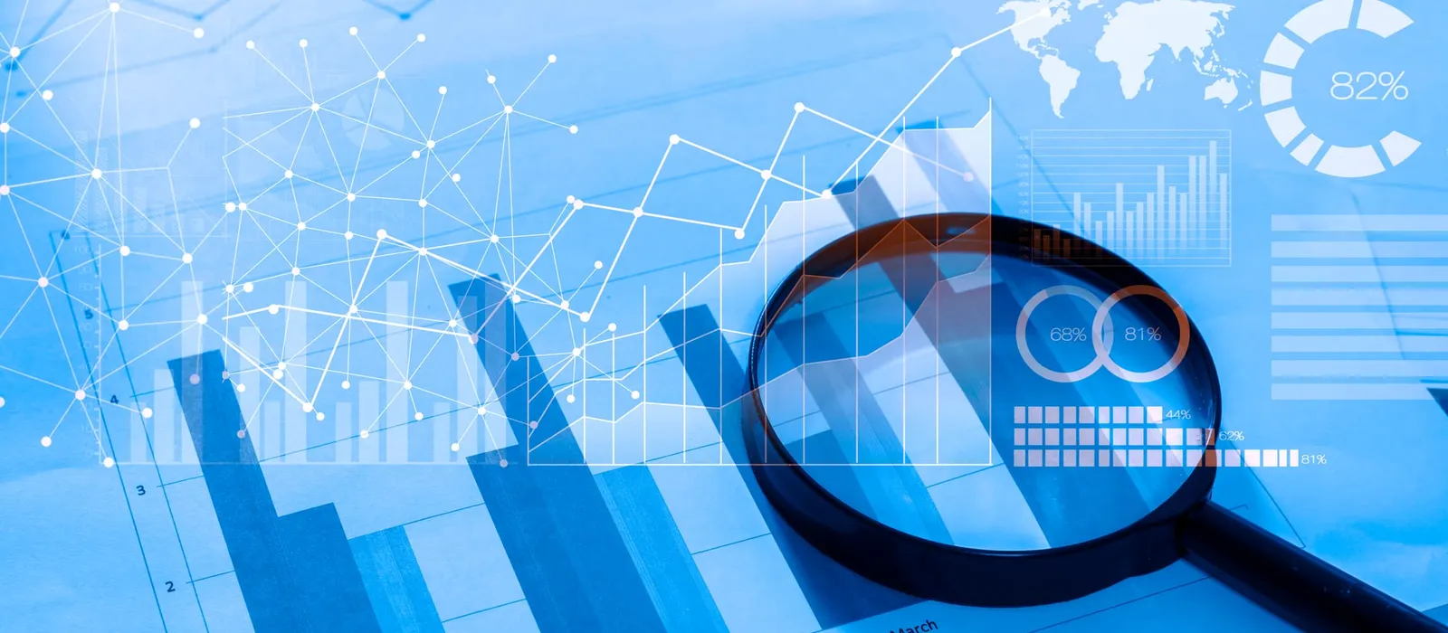 Magnifying glass over documents with analytics charts