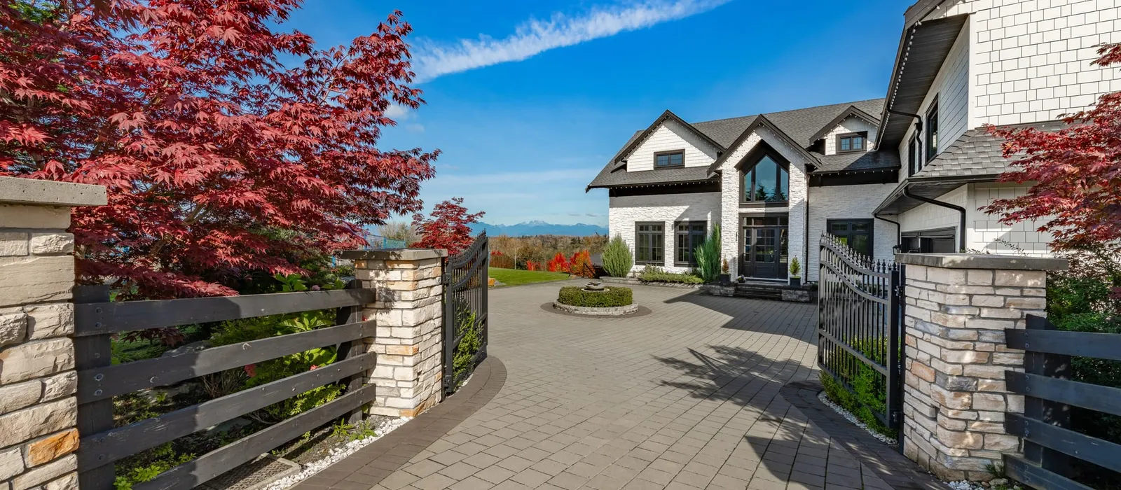 Large estate-style home with a paved drive
