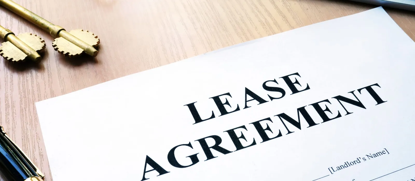 A lease agreement laid out on a desk with a pen