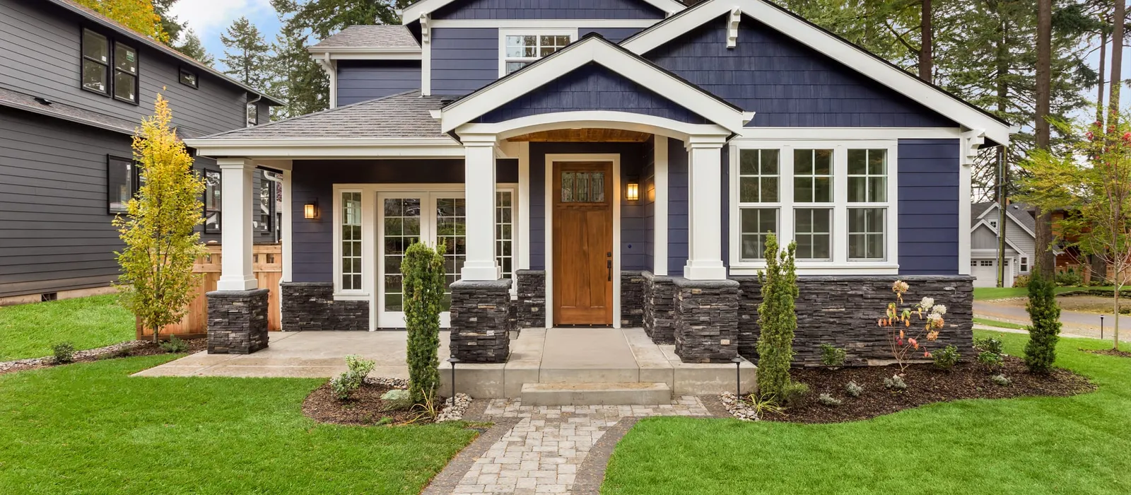 Luxury home exterior with a green lawn and landscaped yard