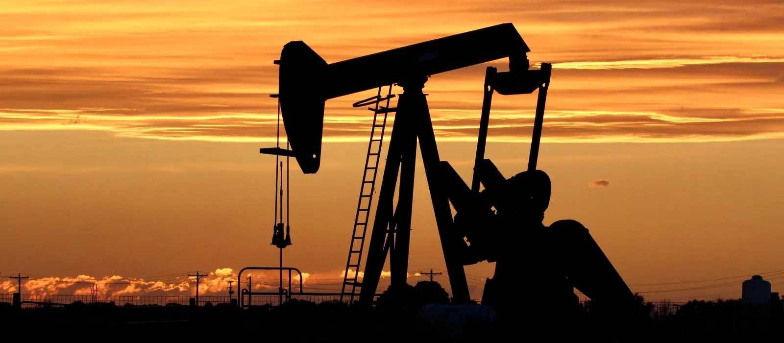 Oil pump jack silhouetted at sunset in West Texas