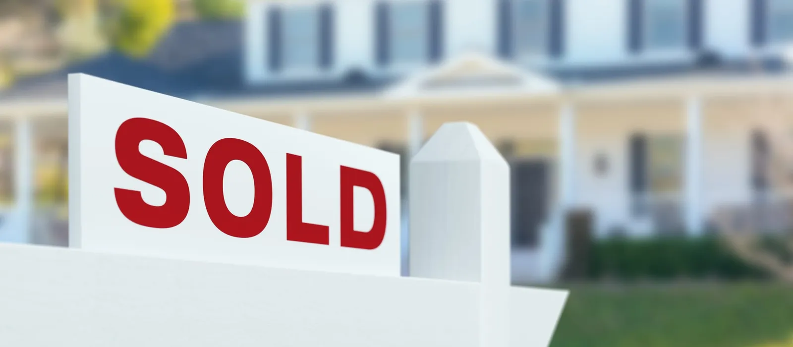 Sold sign in front of a new house