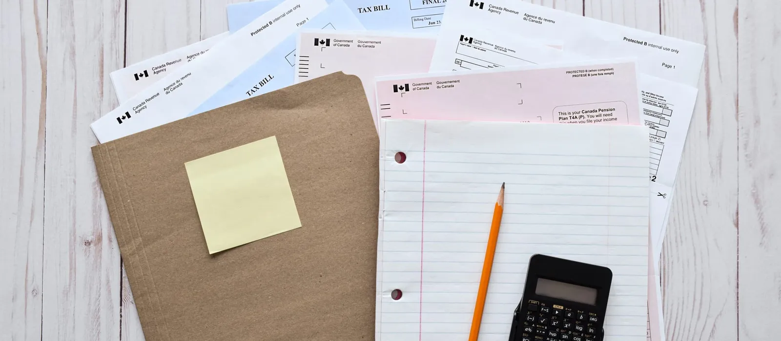 File folder, notepad and calculator for preparing taxes