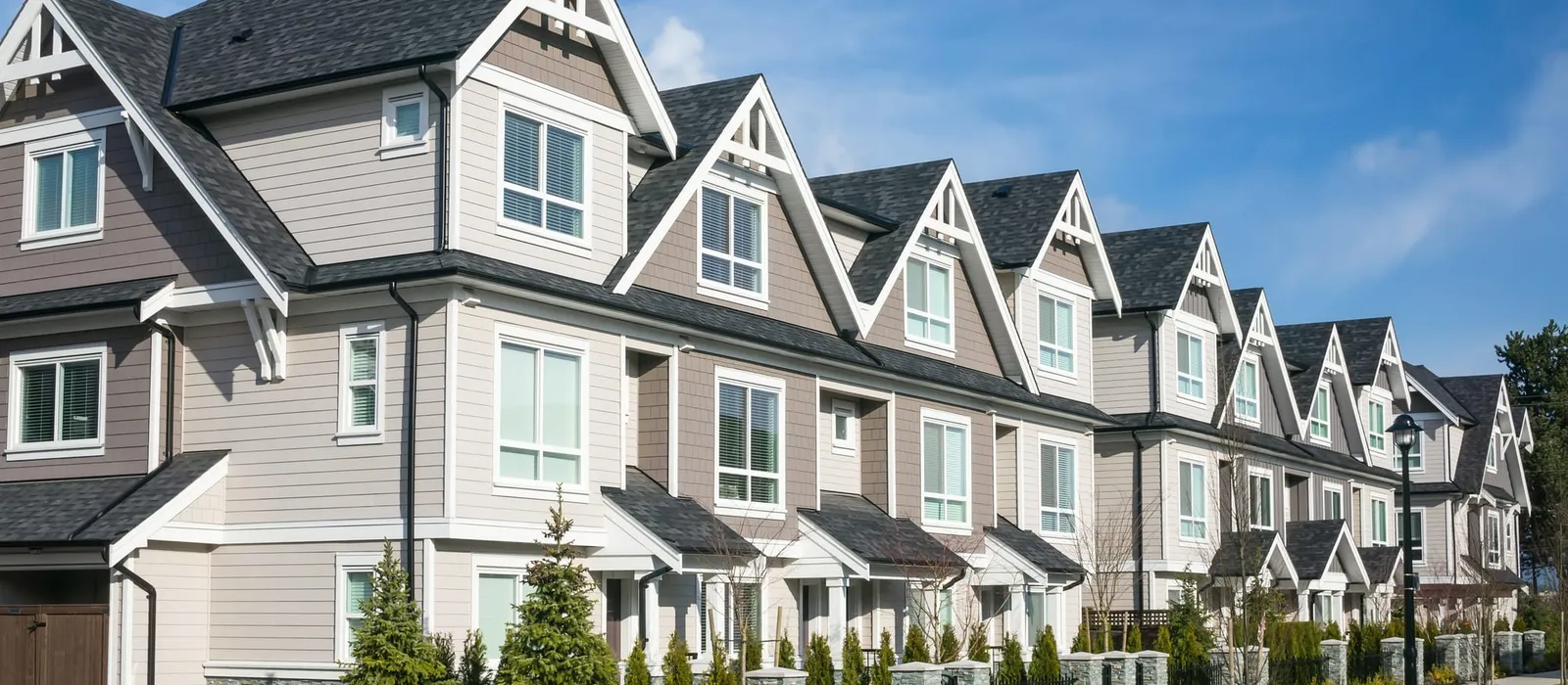 Row of modern townhouses with gabled roofs
