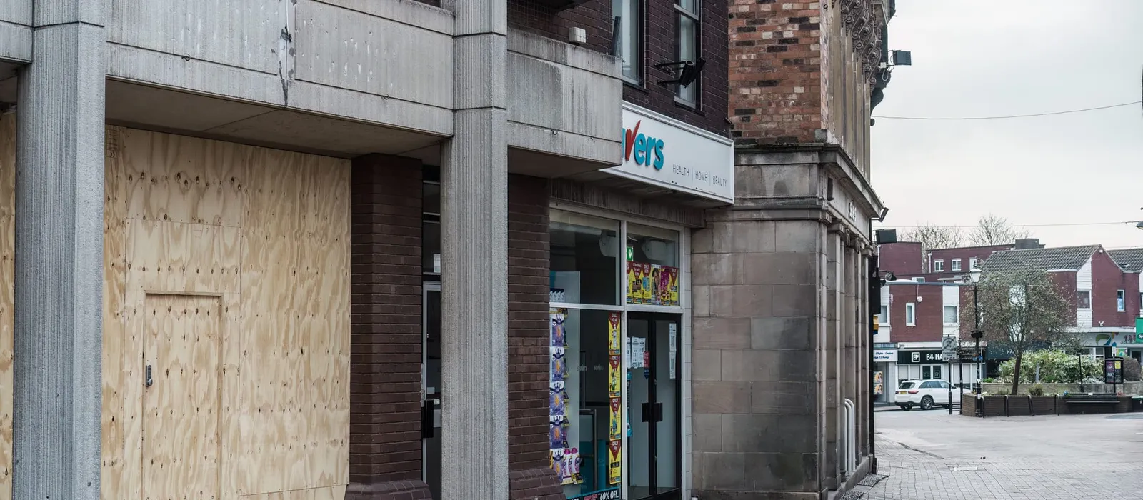 Vacant storefront with a boarded-up door