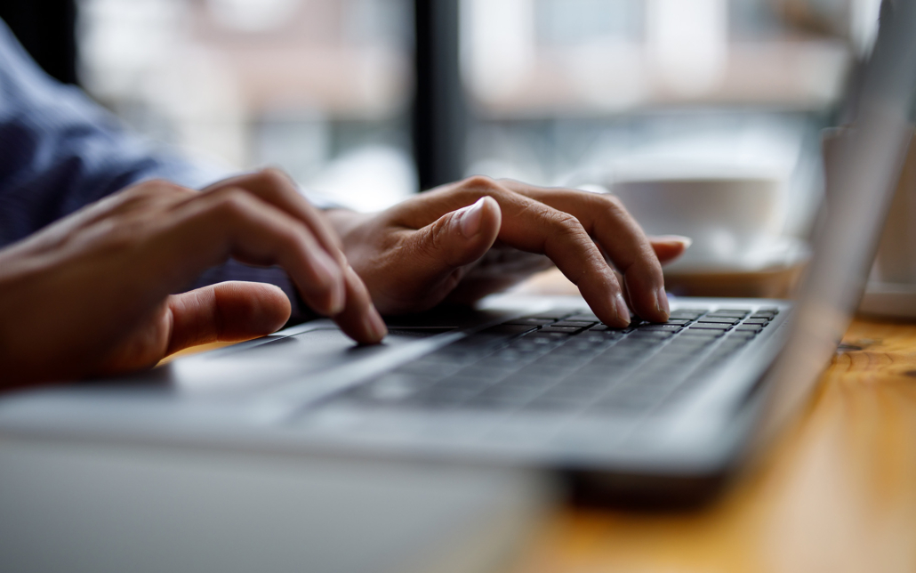 Close Up Of Hands Typing On Computer Keyboard Panoramic Banner