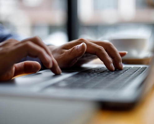Close Up Of Hands Typing On Computer Keyboard Panoramic Banner